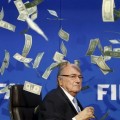 British comedian known as Lee Nelson (unseen) throws banknotes at FIFA President Sepp Blatter as he arrives for a news conference after the Extraordinary FIFA Executive Committee Meeting at the FIFA headquarters in Zurich, Switzerland July 20, 2015. REUTERS/Arnd Wiegmann